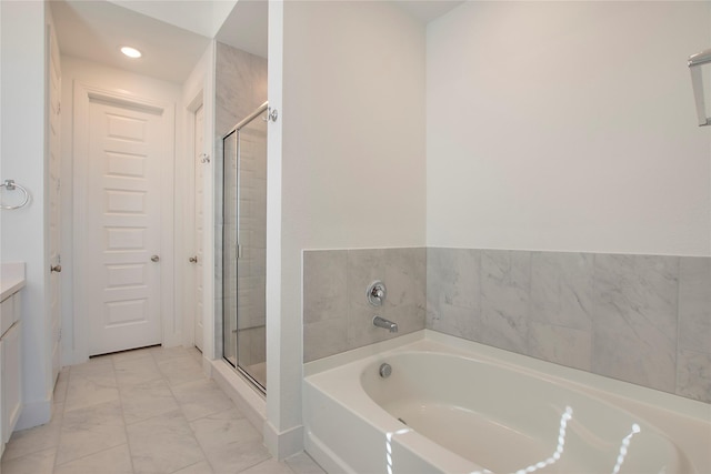 bathroom featuring vanity, a shower stall, a bath, and marble finish floor