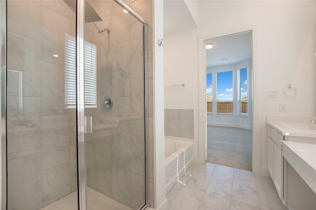 bathroom with a shower stall, baseboards, a bath, marble finish floor, and vanity