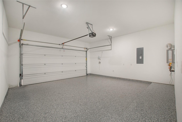 garage featuring electric panel and a garage door opener