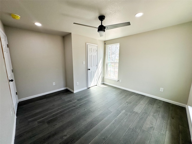 empty room with recessed lighting, baseboards, dark wood finished floors, and ceiling fan