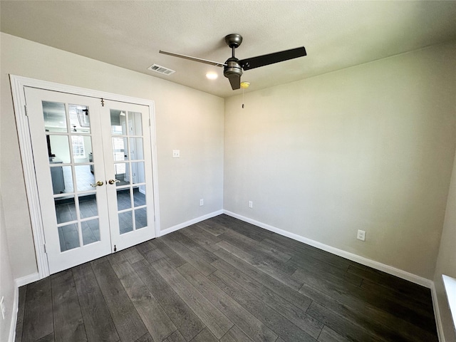 empty room with a ceiling fan, visible vents, baseboards, dark wood finished floors, and french doors