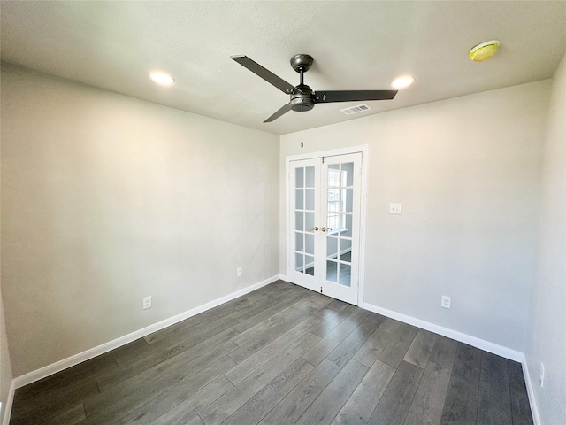 empty room featuring french doors, baseboards, visible vents, and dark wood-style flooring