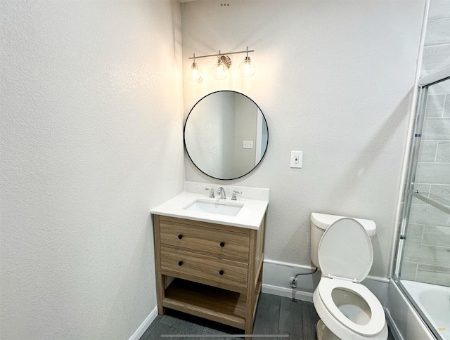 bathroom with combined bath / shower with glass door, baseboards, toilet, and vanity