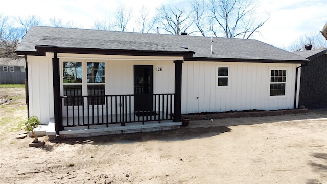 view of front of house with covered porch and a shingled roof