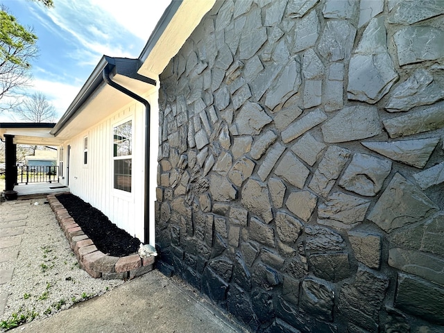 view of side of home featuring stone siding