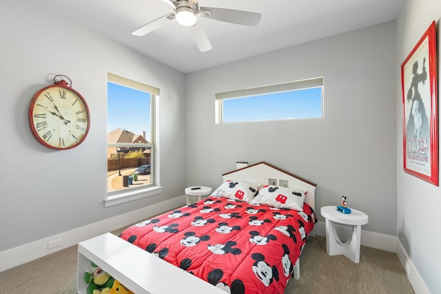 carpeted bedroom featuring baseboards and ceiling fan