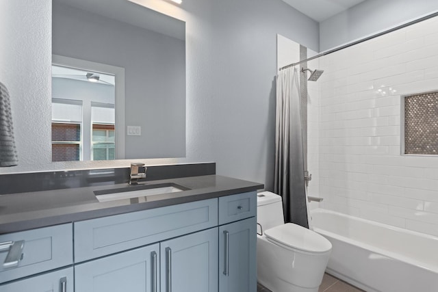 full bath with toilet, shower / tub combo with curtain, a textured wall, tile patterned floors, and vanity