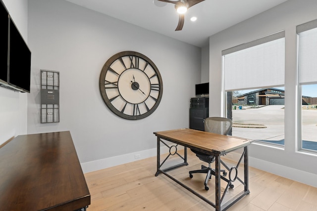 office space with ceiling fan, baseboards, and light wood-style flooring