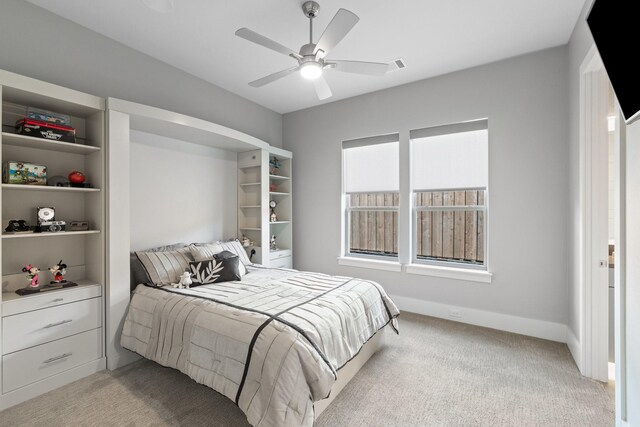 bedroom with visible vents, light carpet, baseboards, and ceiling fan