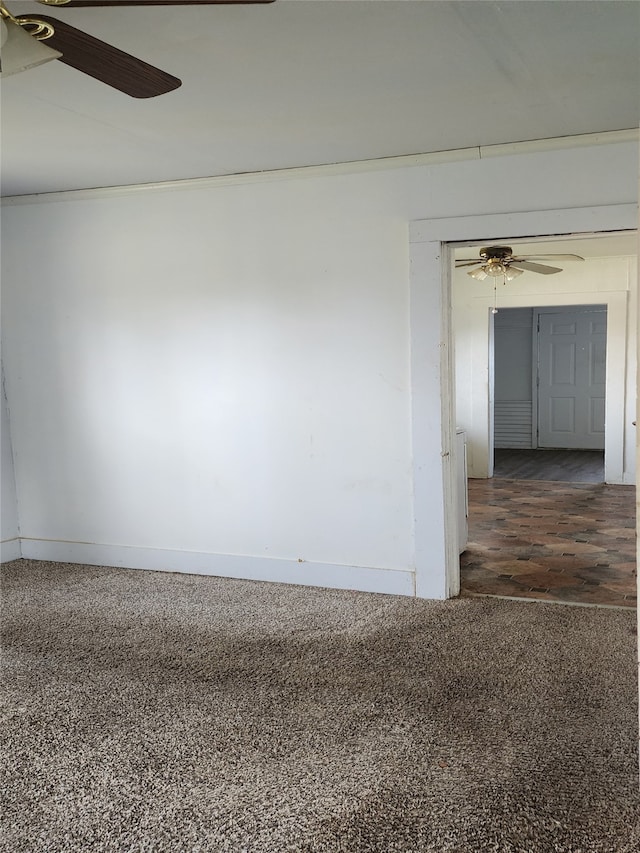 spare room with baseboards and ceiling fan