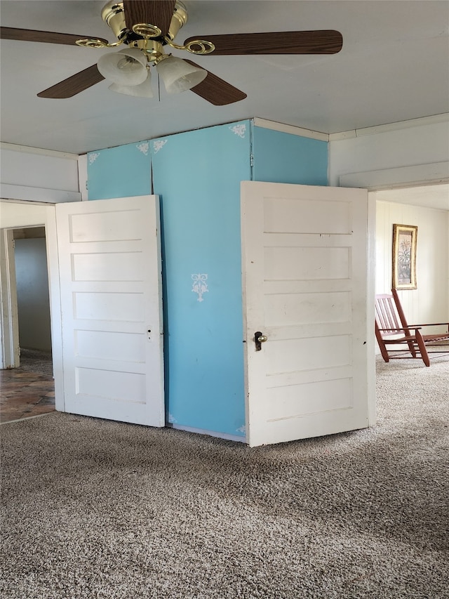 interior space featuring carpet flooring and a ceiling fan