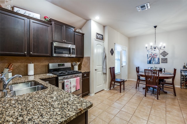 kitchen featuring visible vents, backsplash, dark brown cabinetry, appliances with stainless steel finishes, and a sink