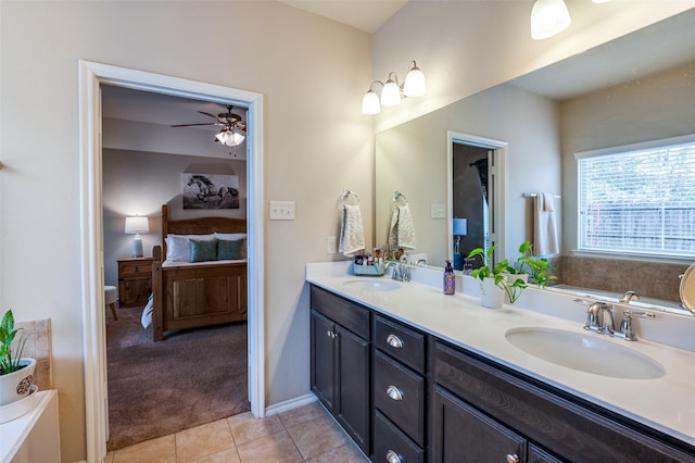 bathroom featuring ensuite bath, double vanity, tile patterned floors, and a sink