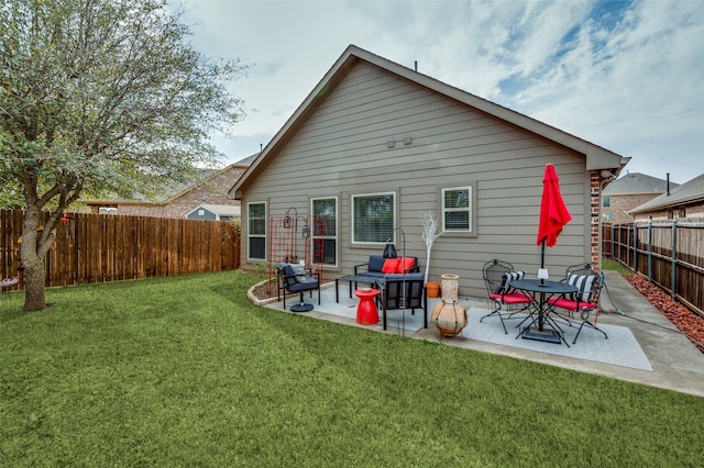 rear view of house with a yard, a patio, and a fenced backyard