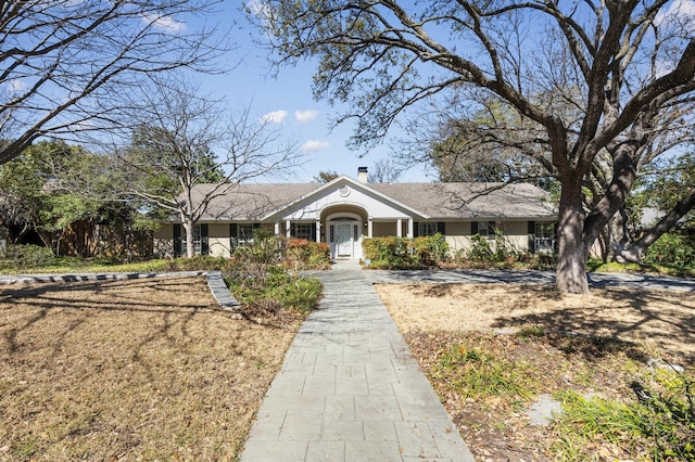 view of front of house featuring a chimney