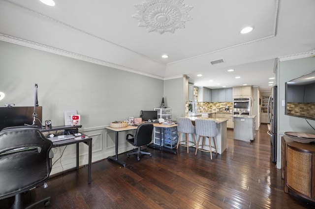 office space with visible vents, ornamental molding, dark wood finished floors, recessed lighting, and wainscoting