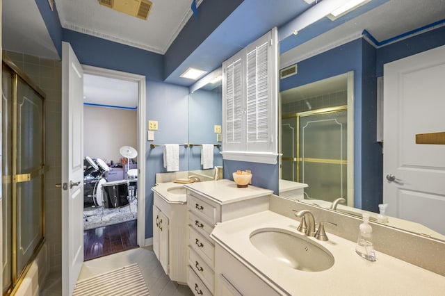 bathroom with an enclosed shower, visible vents, ornamental molding, tile patterned flooring, and vanity