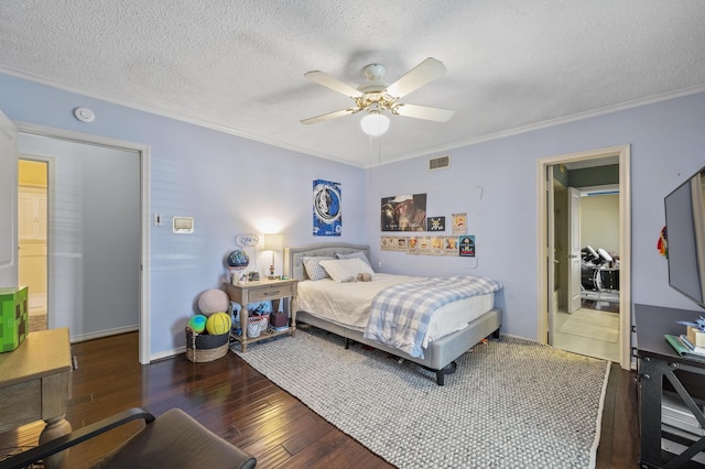 bedroom with visible vents, a textured ceiling, crown molding, and wood-type flooring