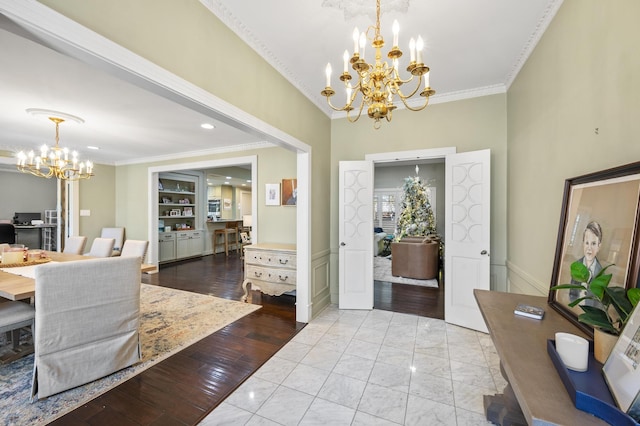 entrance foyer featuring crown molding, a notable chandelier, and wood finished floors