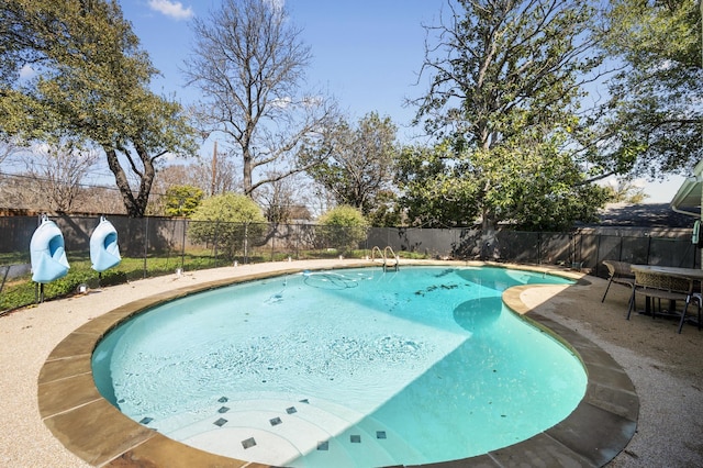 view of pool with a fenced in pool, a fenced backyard, and a patio area