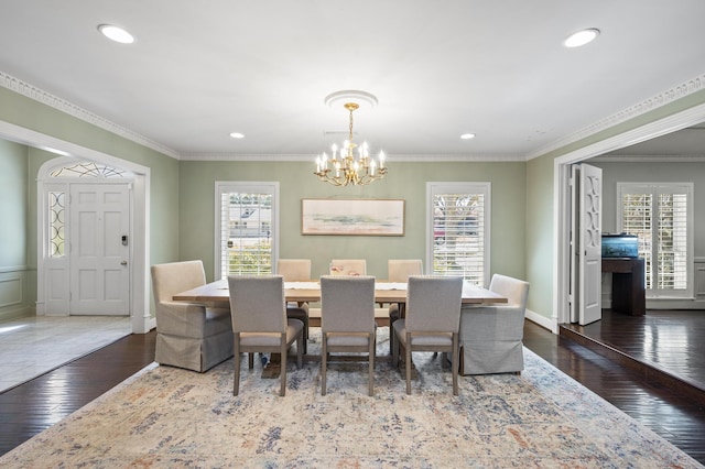 dining space featuring hardwood / wood-style flooring, recessed lighting, a chandelier, and ornamental molding