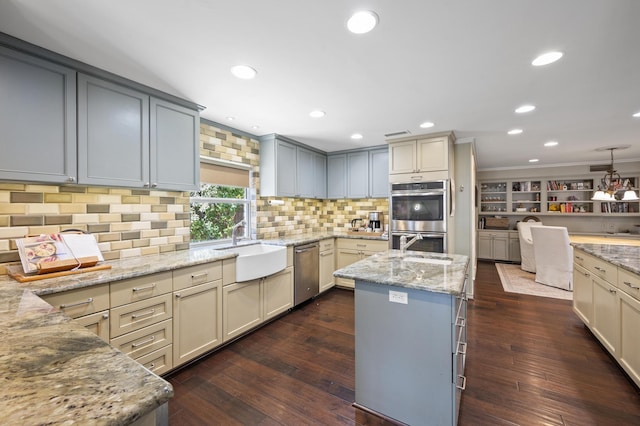 kitchen featuring a sink, light stone countertops, double oven, and dark wood finished floors