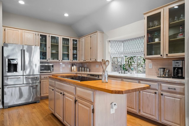 kitchen with light wood-style flooring, light brown cabinets, appliances with stainless steel finishes, and wooden counters