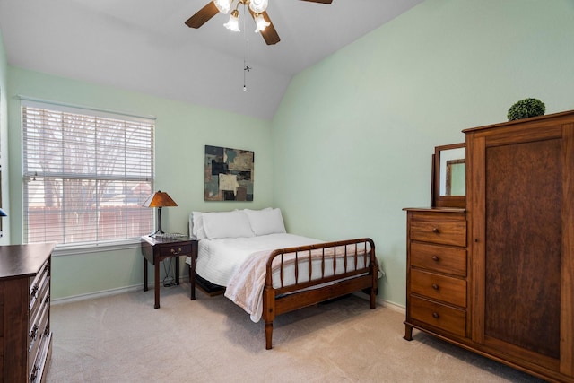 bedroom with baseboards, lofted ceiling, light carpet, and ceiling fan