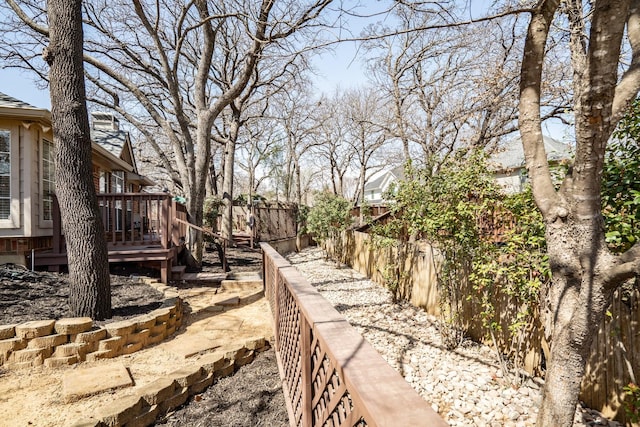 view of yard with fence private yard and a wooden deck