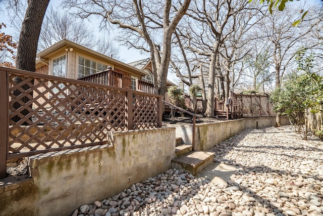 view of yard featuring a deck and stairs