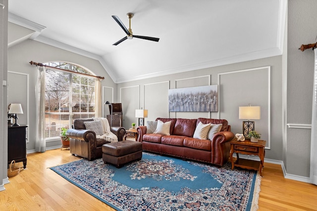 living room featuring lofted ceiling, wood finished floors, baseboards, and ceiling fan