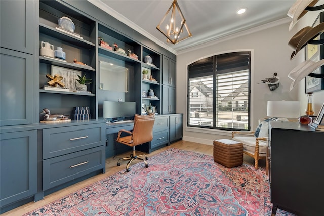 home office featuring light wood finished floors, built in desk, crown molding, and a notable chandelier