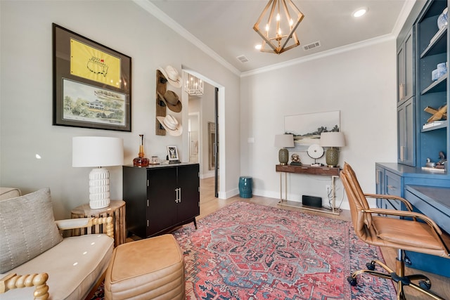 home office with a chandelier, visible vents, crown molding, and light wood-style floors