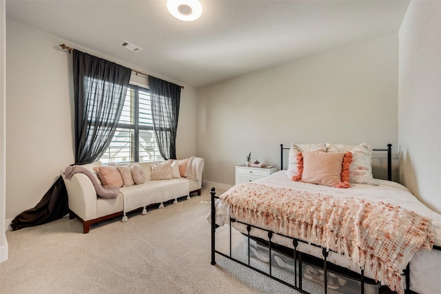 bedroom featuring visible vents, baseboards, and carpet