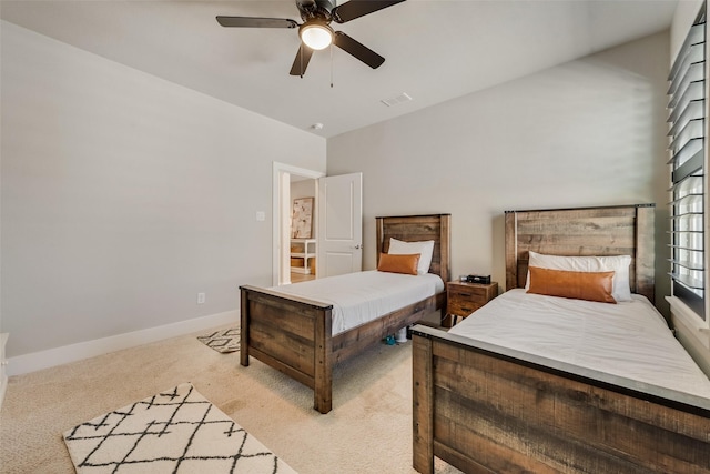 carpeted bedroom featuring visible vents, a ceiling fan, and baseboards