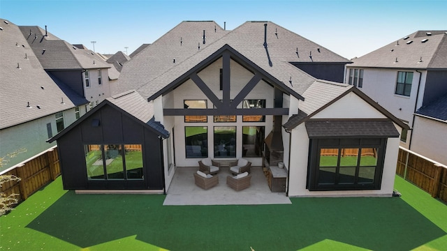 rear view of property with a patio, a fenced backyard, and a shingled roof