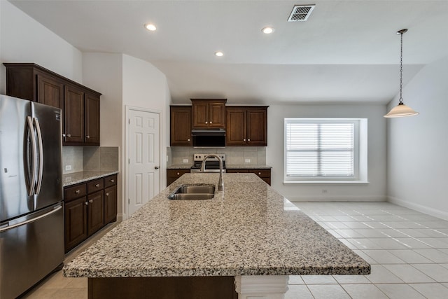 kitchen featuring tasteful backsplash, visible vents, light tile patterned floors, appliances with stainless steel finishes, and a sink