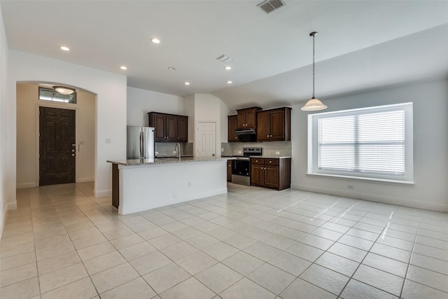 kitchen featuring light tile patterned floors, decorative backsplash, and stainless steel appliances