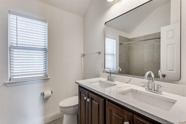 bathroom featuring double vanity, tile patterned floors, toilet, and a sink