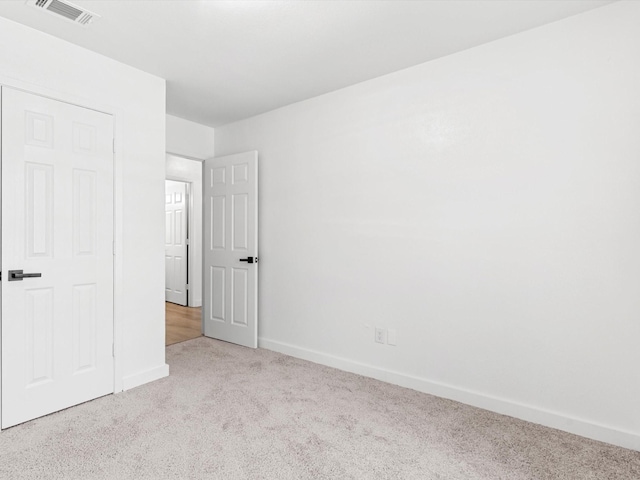 unfurnished bedroom featuring carpet flooring, baseboards, and visible vents