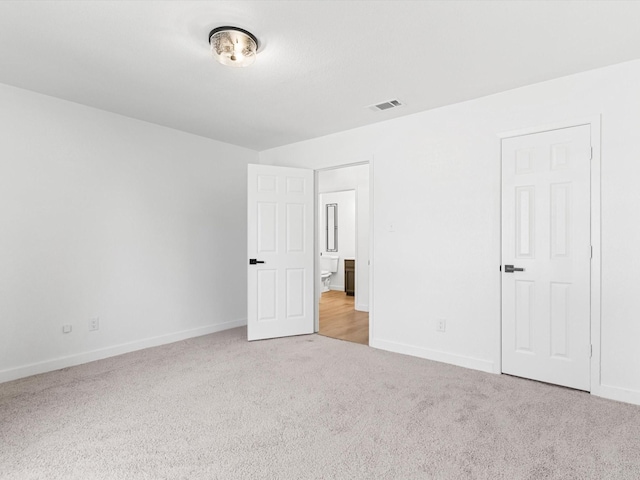 unfurnished bedroom with visible vents, baseboards, and carpet