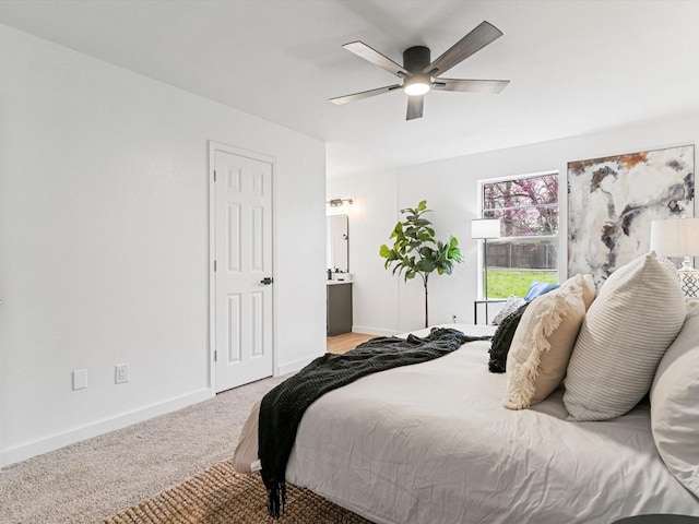 bedroom featuring carpet flooring, a ceiling fan, baseboards, and ensuite bathroom