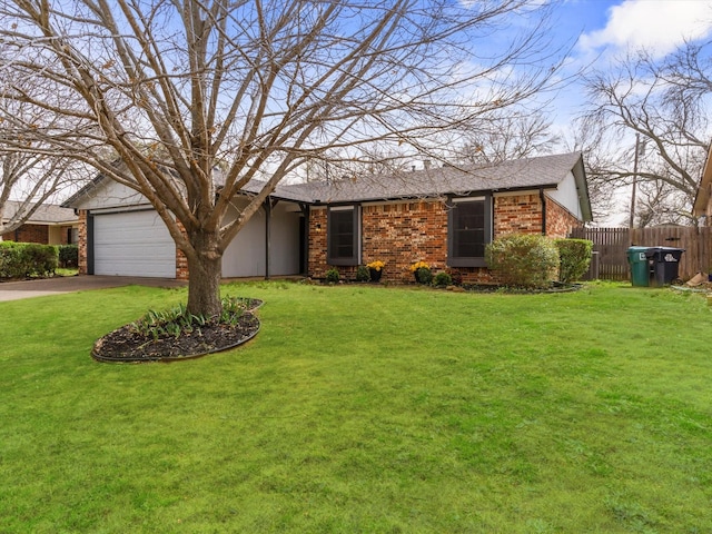 view of front facade featuring a front lawn, fence, brick siding, and driveway