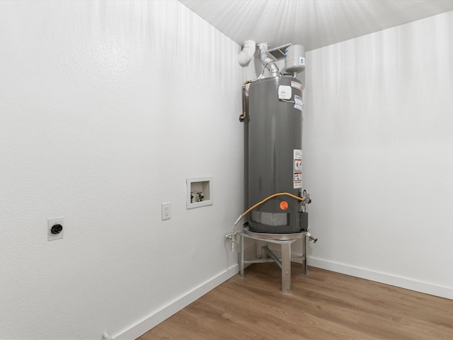 clothes washing area with wood finished floors, laundry area, water heater, electric dryer hookup, and washer hookup