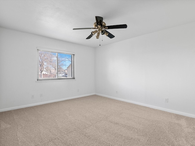 spare room with ceiling fan, baseboards, and carpet floors