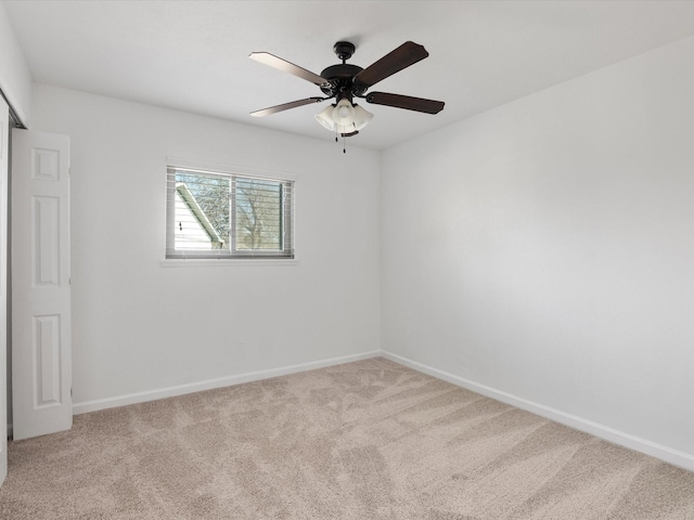 unfurnished room with carpet flooring, a ceiling fan, and baseboards