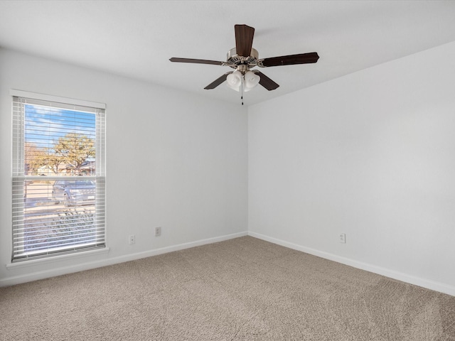 unfurnished room featuring baseboards, carpet, and a ceiling fan