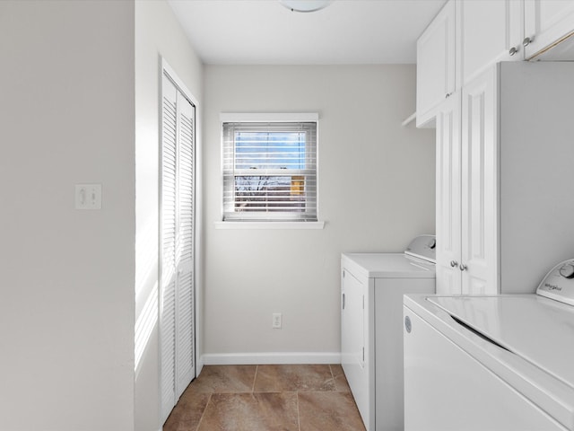 laundry room featuring light tile patterned flooring, cabinet space, baseboards, and separate washer and dryer