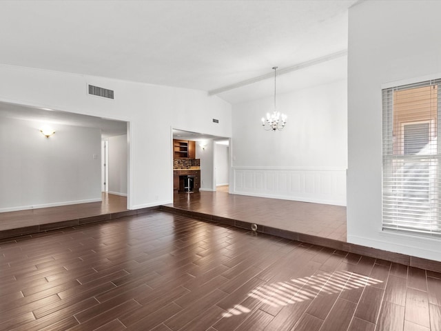 interior space featuring visible vents, baseboards, dark wood finished floors, a chandelier, and lofted ceiling