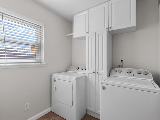 clothes washing area with washer and dryer, cabinet space, baseboards, and tile patterned flooring